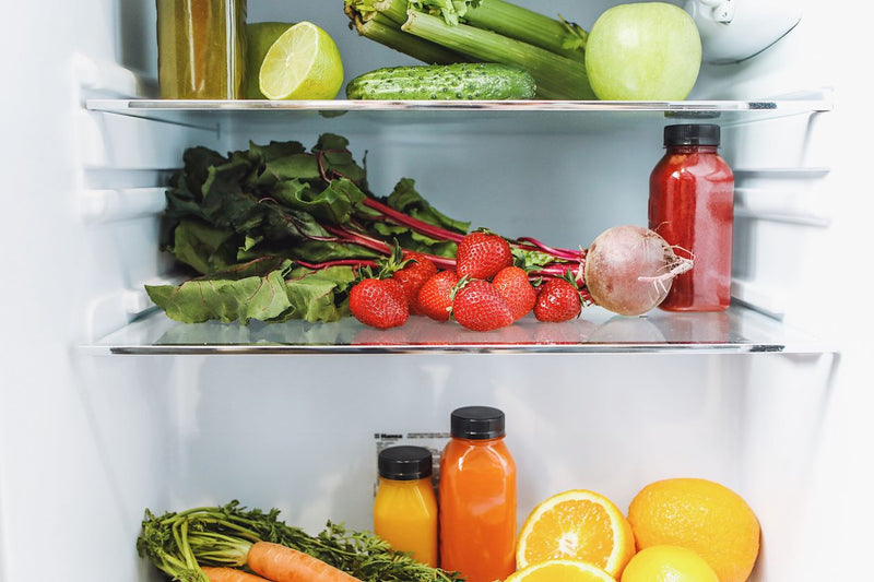 Fresh fruits and vegetables organized in a refrigerator