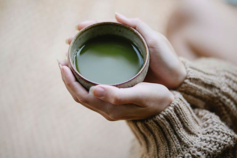 Woman holding a warm cup of tea